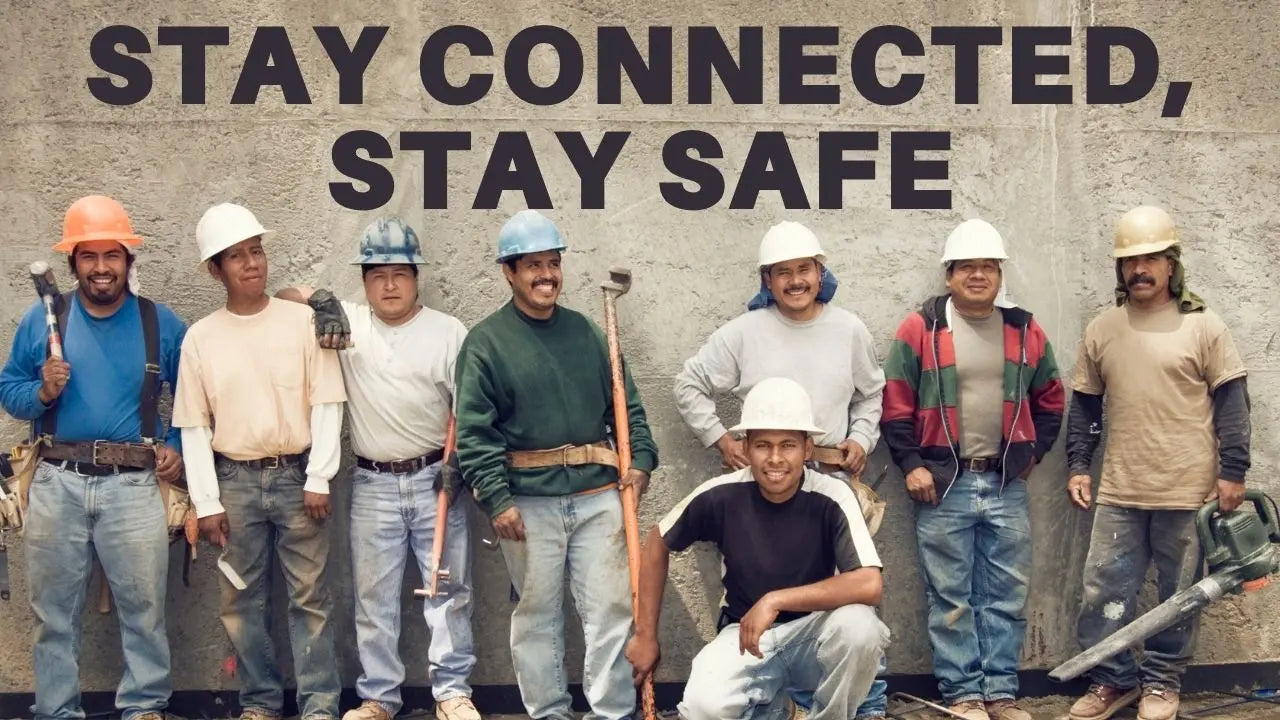 Group of construction workers using durable job site radios for improved communication and safety on a construction site, promoting efficient team coordination in a challenging environment.